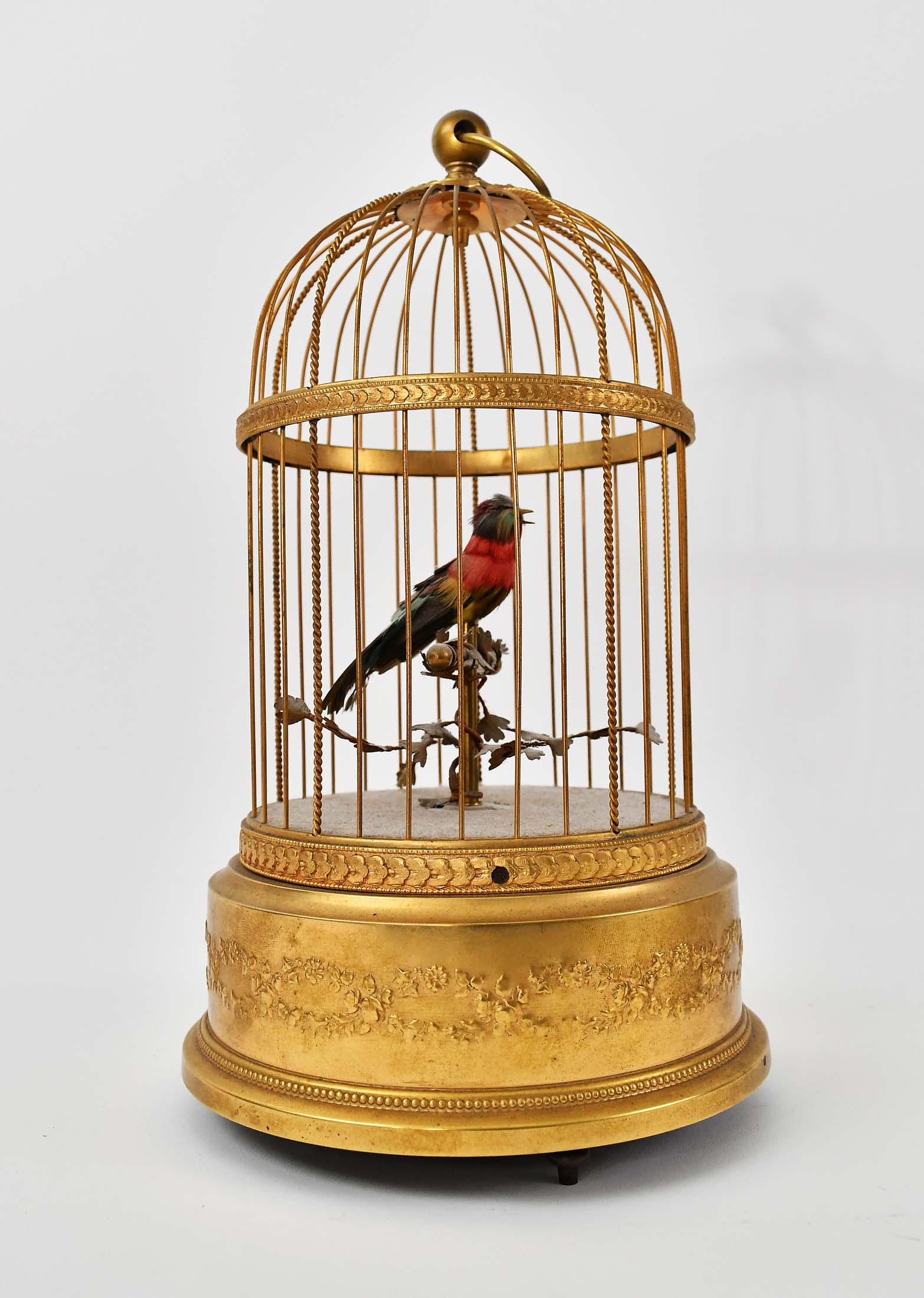 CONTINENTAL ANTIQUE AUTOMATON MUSICAL BIRD CAGE: French or German. The domed circular cage with a small feathered songbird, with stop/start lever. Height 11 in. Diameter 6.5 in. (Cond: good, presently in working order)