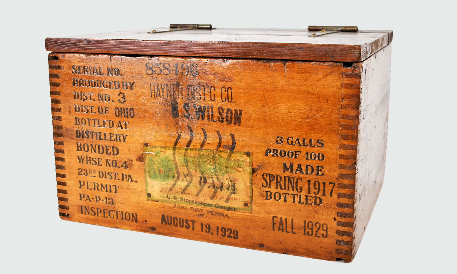 PROHIBITION PINE DISTILLED SPIRITS CASE: Dated 1929. Rectangular with a hinged lid, Hayner Distribution Co., H.S. Wilson, with date of distilled spirits spring 1917, inspection stamps, and indicator of Mass. tax paid, and with Penna. Permit 