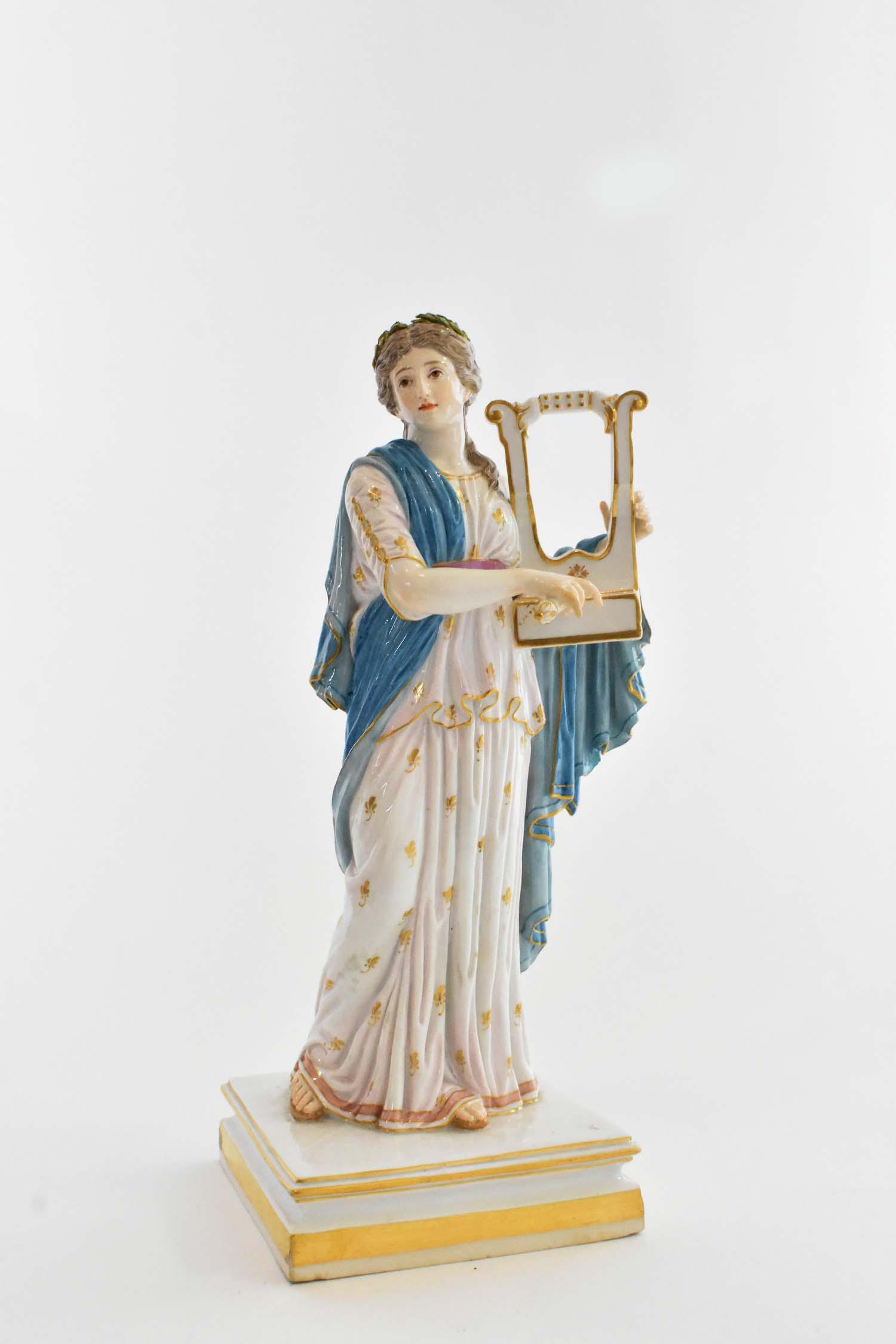 MEISSEN PAINTED PORCELAIN FIGURE OF A MUSE: Circa 1900. The underside with crossed swords in underglaze blue. The classically clad maiden playing a harp, gilt highlights. Height 11 in. Width at base 4 in. square. Note: Repair to right hand pink