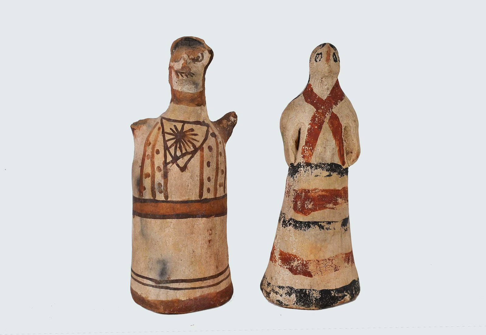 MINOAN & CYPRIOT PAINTED POTTERY MALE & FEMALE: The male figure Minoan, circa 1000 B.C.E., painted to simulate attire in red and black on a buff ground; the female figure, Cypriot, circa 700 B.C.E., similarly decorated. The lot is accompanied by a 