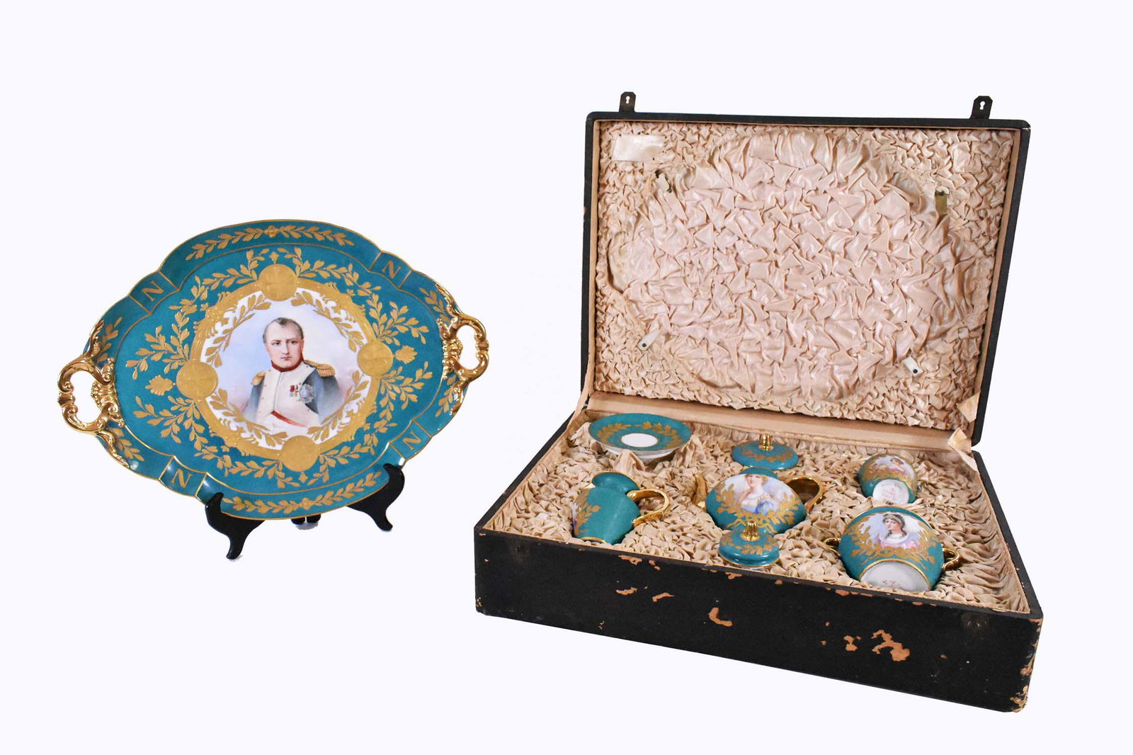 SEVRES NAPOLEONIC PORCELAIN TEA SERVICE: Late 19th Century. The underside marked Sevres in red. Comprising: a tea pot, a covered sugar, a creamer, two cups, two saucers and an oval two handled tray, the tray painted with a portrait of Napole
