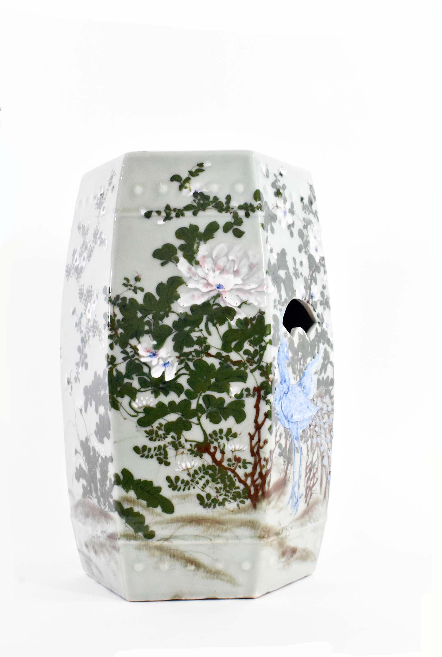 CHINESE CELADON DECORATED PORCELAIN GARDEN SEAT: Hexagonal, decorated with birds and a flower-filled basket amidst blossoming shrubs. Height 19 in. Diameter 11 in.