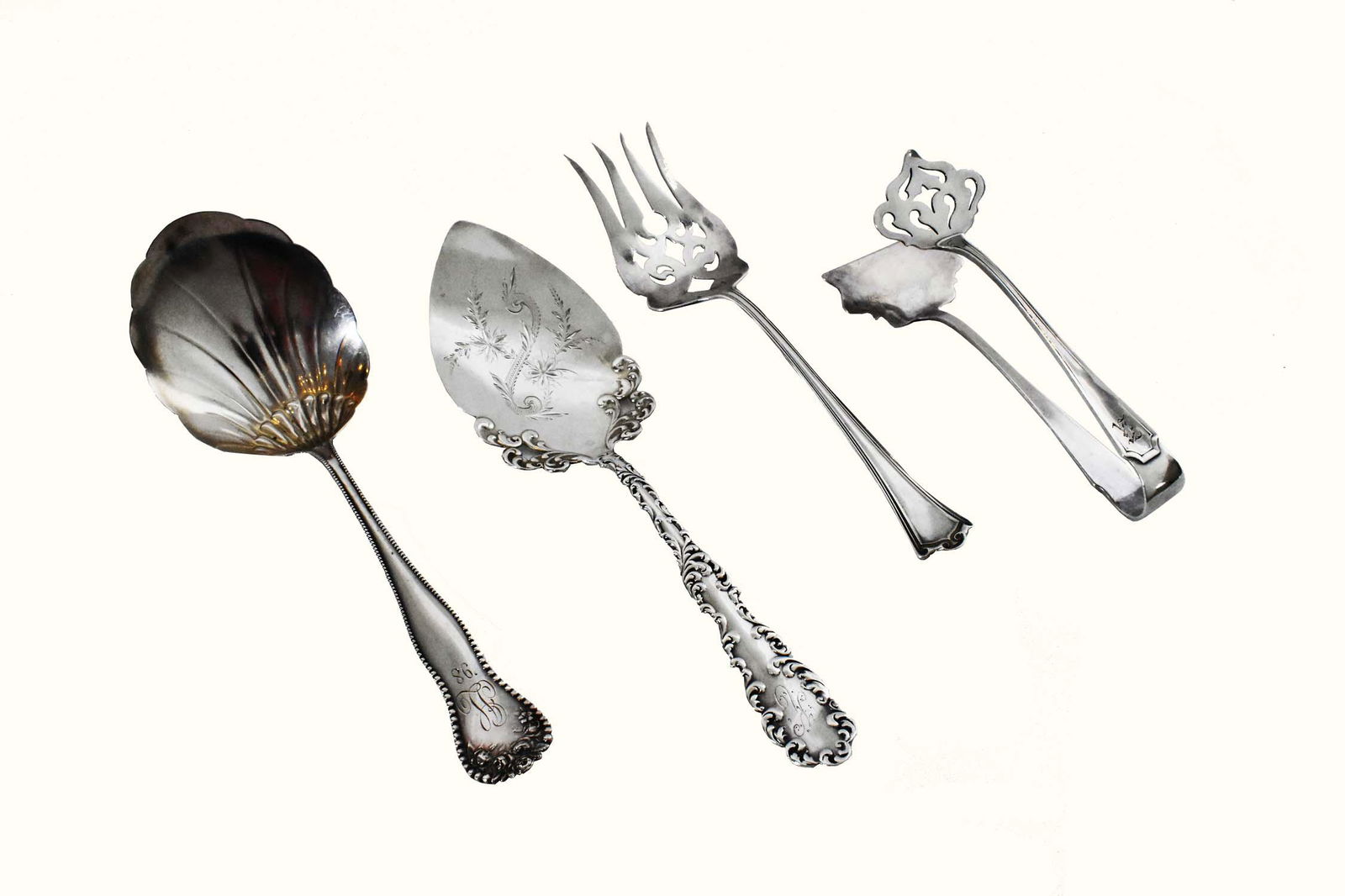 FOUR AMERICAN STERLING SERVING PIECES: Each marked. Comprising: asparagus tongs, a cake spoon, a berry spoon and a fish fork. 9.7 oz. Length 5.75 to 9.5 in.
