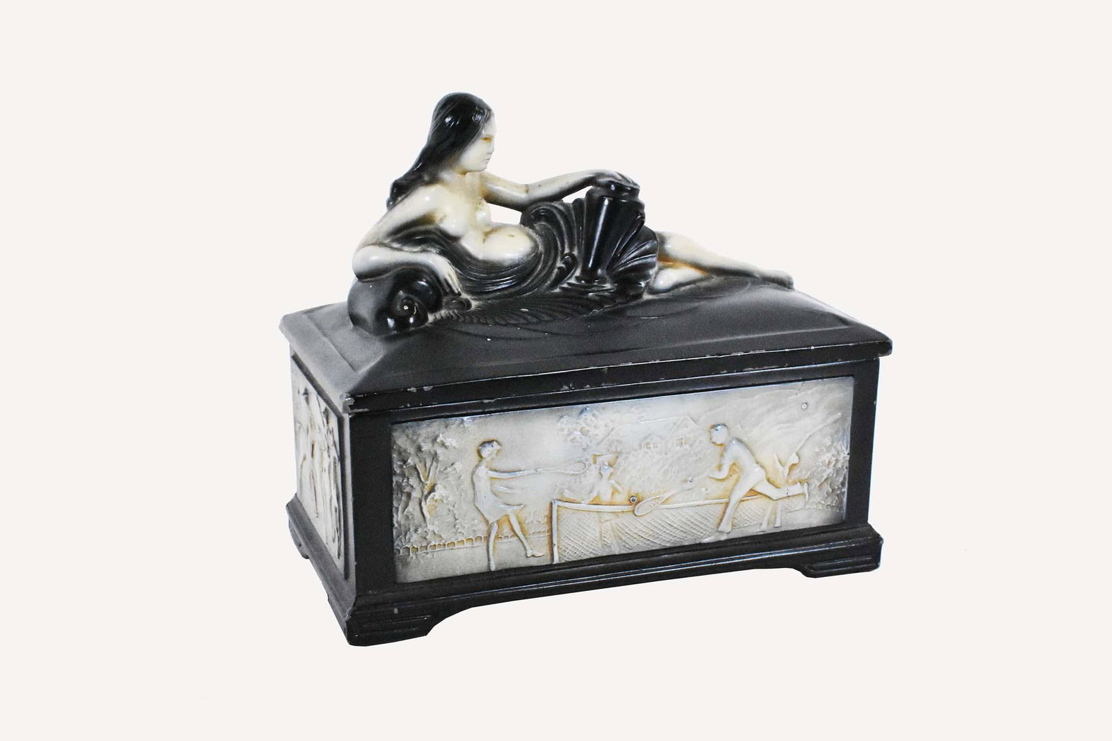 ART DECO PAINTED METAL GENTLEMENS CIGARETTE BOX: Second quarter 20th Century. The rectangular box decorated with panels containing athletic scenes of figures engaged in gulf, polo, tennis and football, the cover with a semi-clad reclining maiden. He