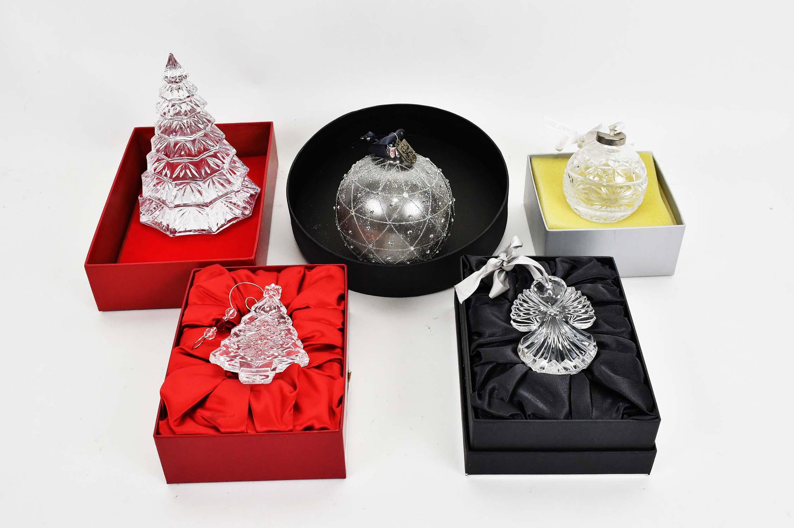 FIVE WATERFORD CRYSTAL CHRISTMAS ORNAMENTS: Comprising: a large tree, a smaller tree, a large ball, a smaller ball, and an angel, all in an individual Waterford box. Height of largest tree 6.75 in.