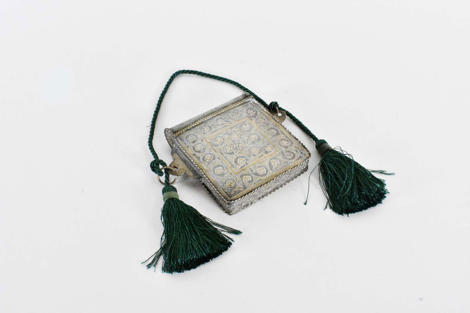 VINTAGE MOROCCAN METAL QURAN PURSE: Square, with a hinged lid, chased allover with scrolling foliage. Height 5.5 in. Width 6.5 in.