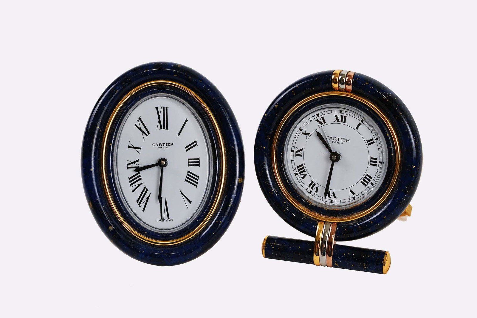 TWO CARTIER FAUX LAPIS AND BRASS QUARTZ CLOCKS: Modern. Marked Cartier on the dial and the reverse. Height 3.5 in.