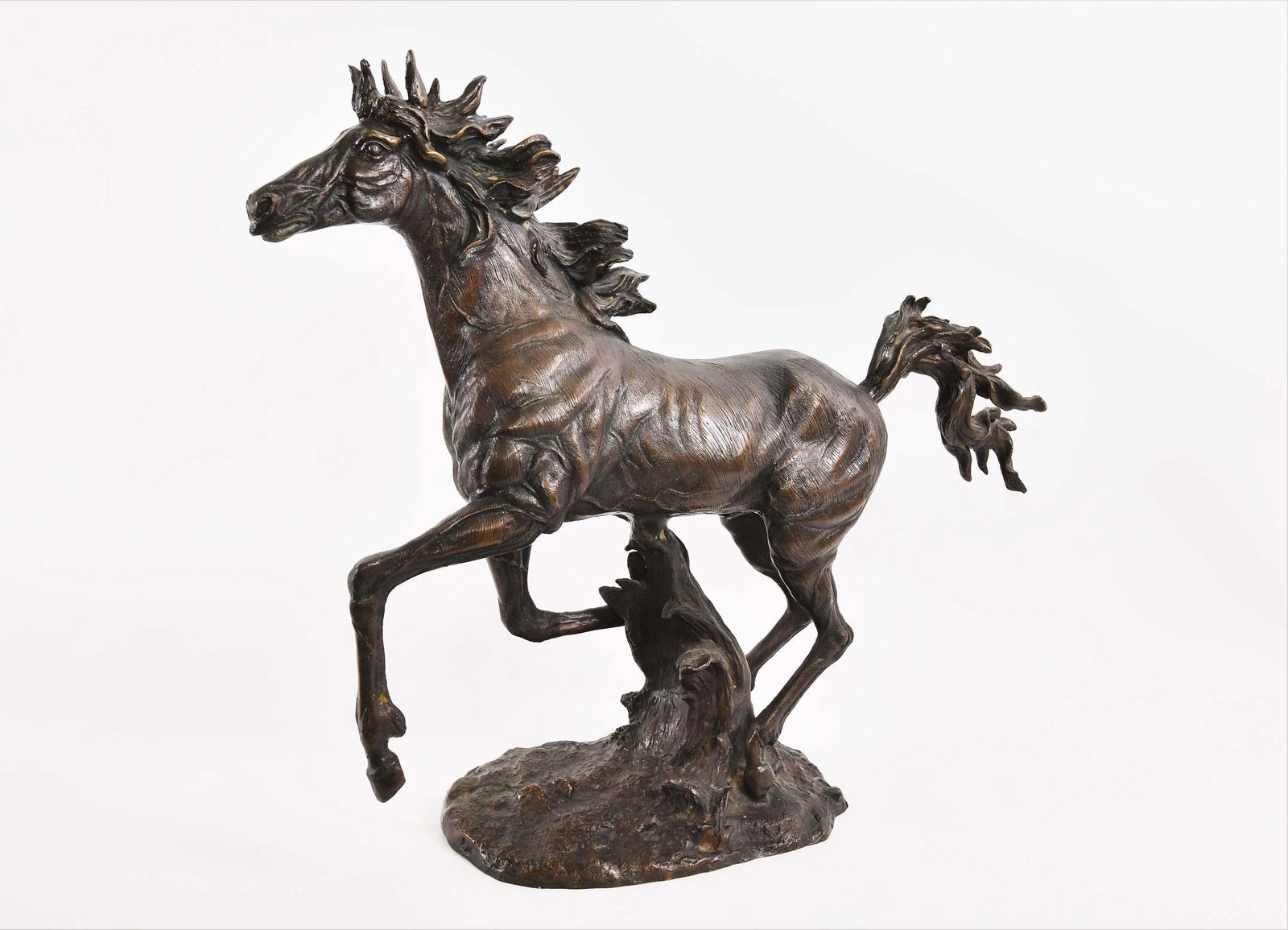 PATINATED BRONZE OF A GALLOPING MARE: Realistically modelled, on an oval base, gold toned brown patina. Height 22.5 by 28 in. (Cond: good)