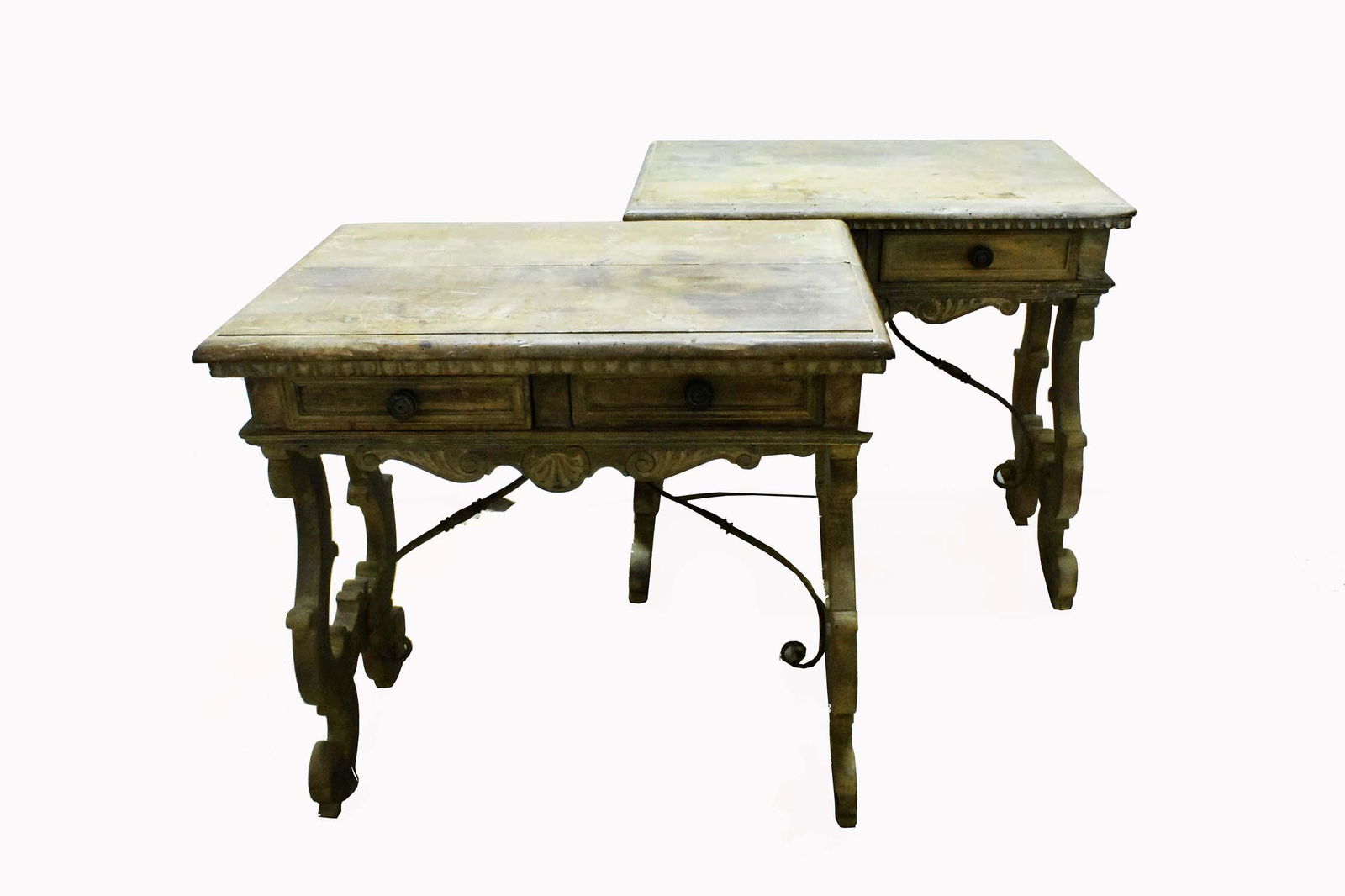 PAIR OF ITALIAN BAROQUE BLEACHED WALNUT SIDE TABLES: 19th Century. The rectangular molded tops with a carved edge, above a drawer carved to simulate two drawers, above a shaped apron, on scroll-carved trestle supports, joined by two iron supports. Heigh