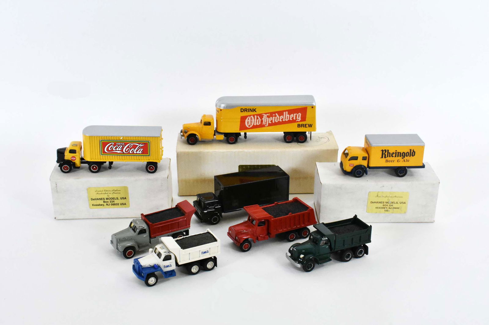 GROUP OF EIGHT DEHAINES DIE-CAST TRUCKS: Comprising: a UPS shipping tractor trailer, an Old Freidelberg Brew delivery truck, a Coco-Cola delivery truck, a Rheingold Beer and Ale Truck and four dump trucks. Length of largest 9 in., smallest 4