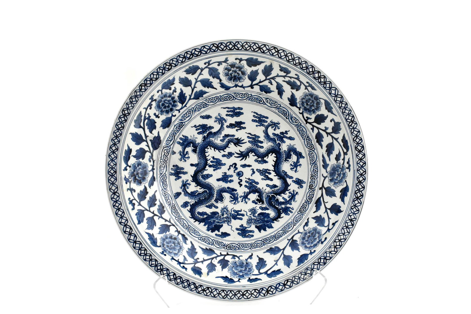 CHINESE BLUE AND WHITE LARGE CHARGER: The underside with an Imperial six-character mark for the Emperor Yongzheng within a double circle in underglaze blue. The center recess with opposing five-claw dragons amidst swirling clouds, the slo