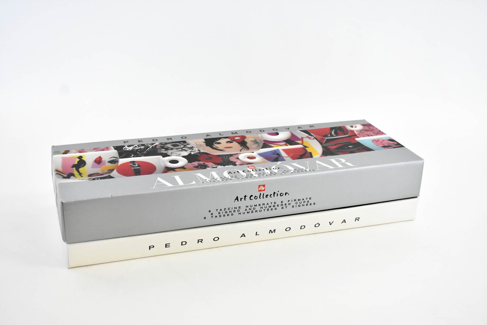 ILLY ART COLLECTION ALMODOVAR PORCELAIN COFFEE SET: Boxed. Complete with four saucers, four cups, four spoons and a presentation booklet. Box measuring 7.5 by 20 in.