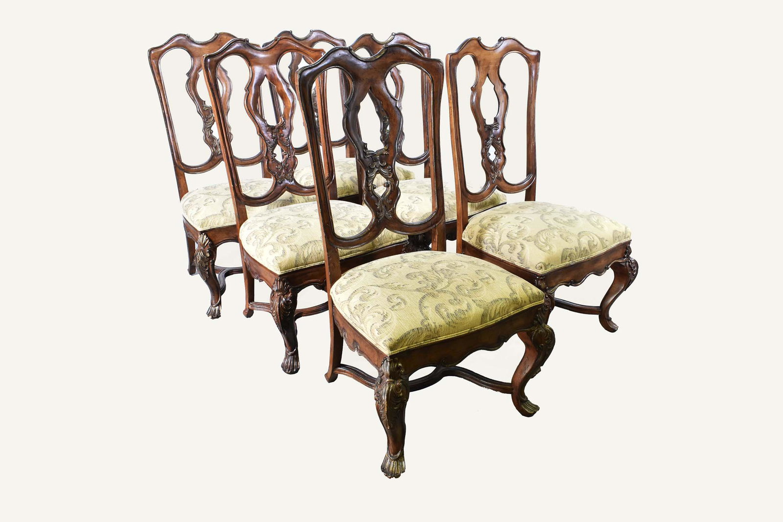 SIX VENETIAN ROCOCO STYLE PARCEL GILT SIDE CHAIRS: Ferguson & Copeland Ltd. Each shaped open back carved with stylized leafage, the over-upholstered seats with rails similarly carved, raised on leaf and shell carved cabriole legs ending in carved shap