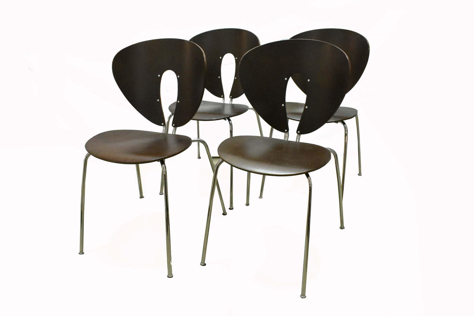 SET OF FOUR CONTEMPORARY STACKABLE CHAIRS: Designed by Jesus Gasca for Stua Contemporary Furniture Collections, Spain. The multiply taupe stained wood veneered backs and seats with a stainless steel back support continuing to form slightly fla