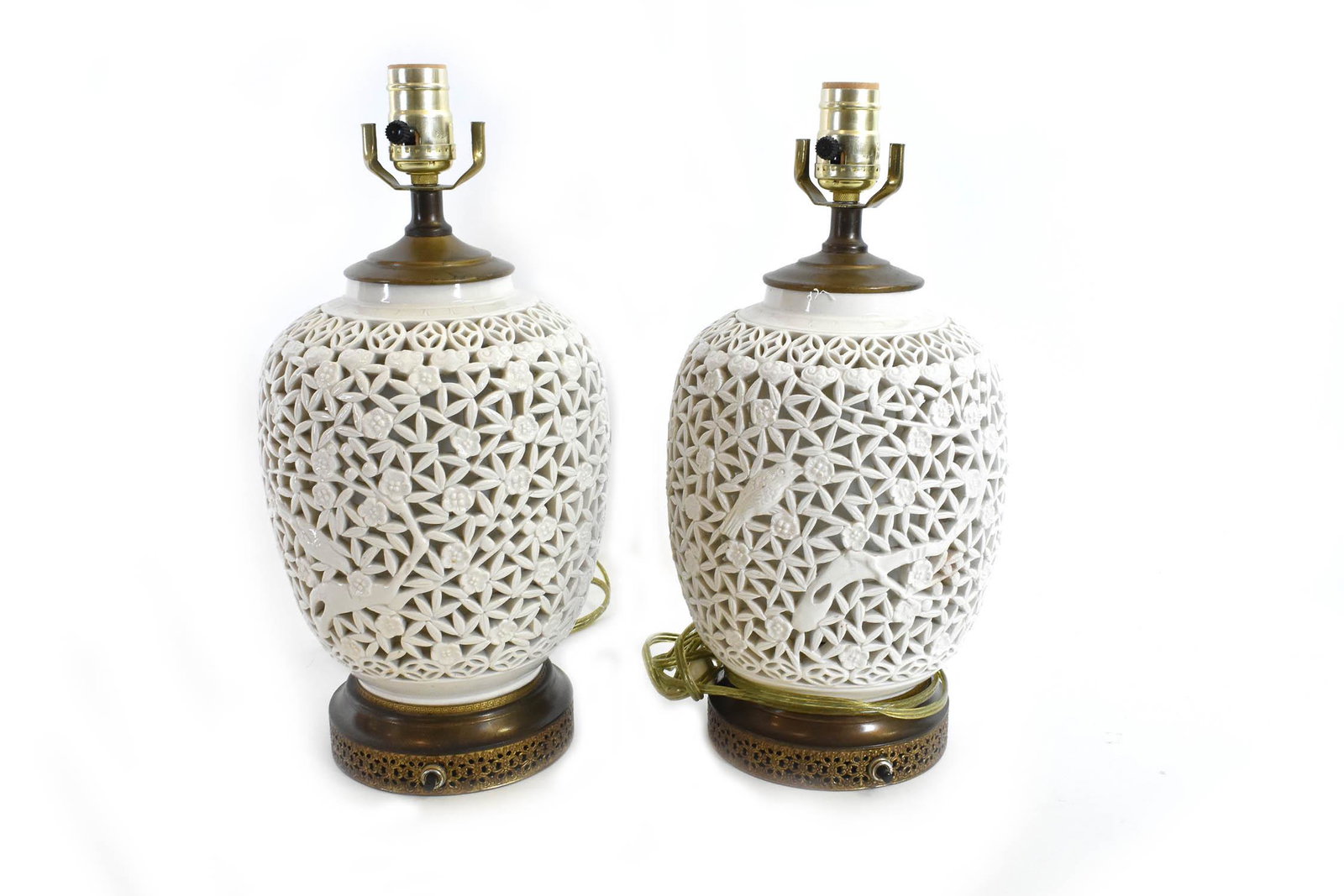 PAIR OF CHINESE RETICULATED PORCELAIN LAMPS: Each of baluster shape, pierced allover with foliage and birds, set in a metal base, drilled. Height 9 in. Diameter at shoulder 7 in. Height overall 15 in. Property of a Cuban/American Gentleman, Key 