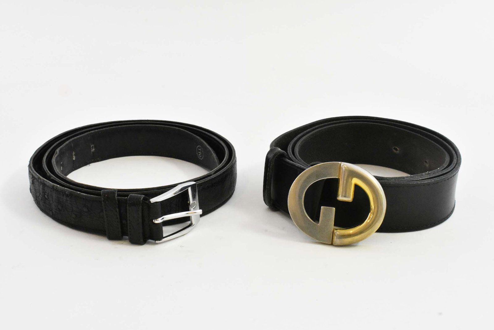 TWO GUCCI BLACK LEATHER MENS BELTS: The buckle in the form of a double-G, marked Gucci Italy. Together with another black leather belt, bearing a Gucci stamp. (2 pcs) Provenance: Property of The Haggstrom Trust, Jupiter, FL