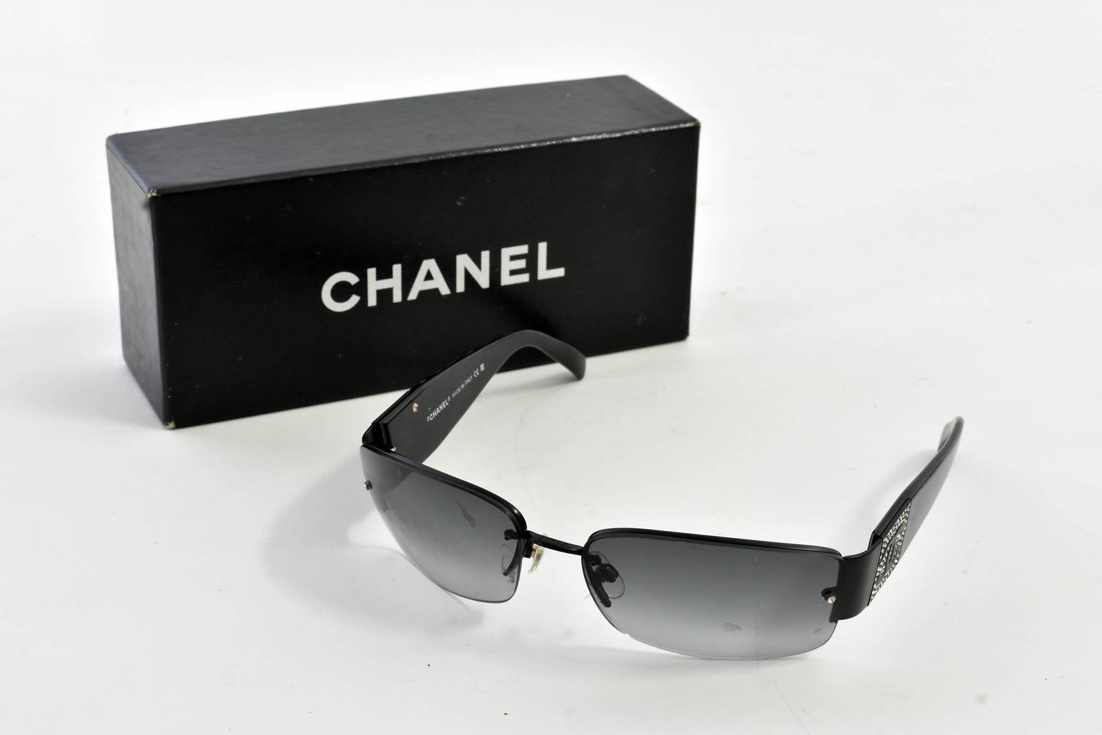 PAIR OF CHANEL SUNGLASSES: Marked on the right side, Chanel Made in Italy CE, the left, 4117-B c.101/8G 62016 125, black graded lens, in an associated Chanel box.