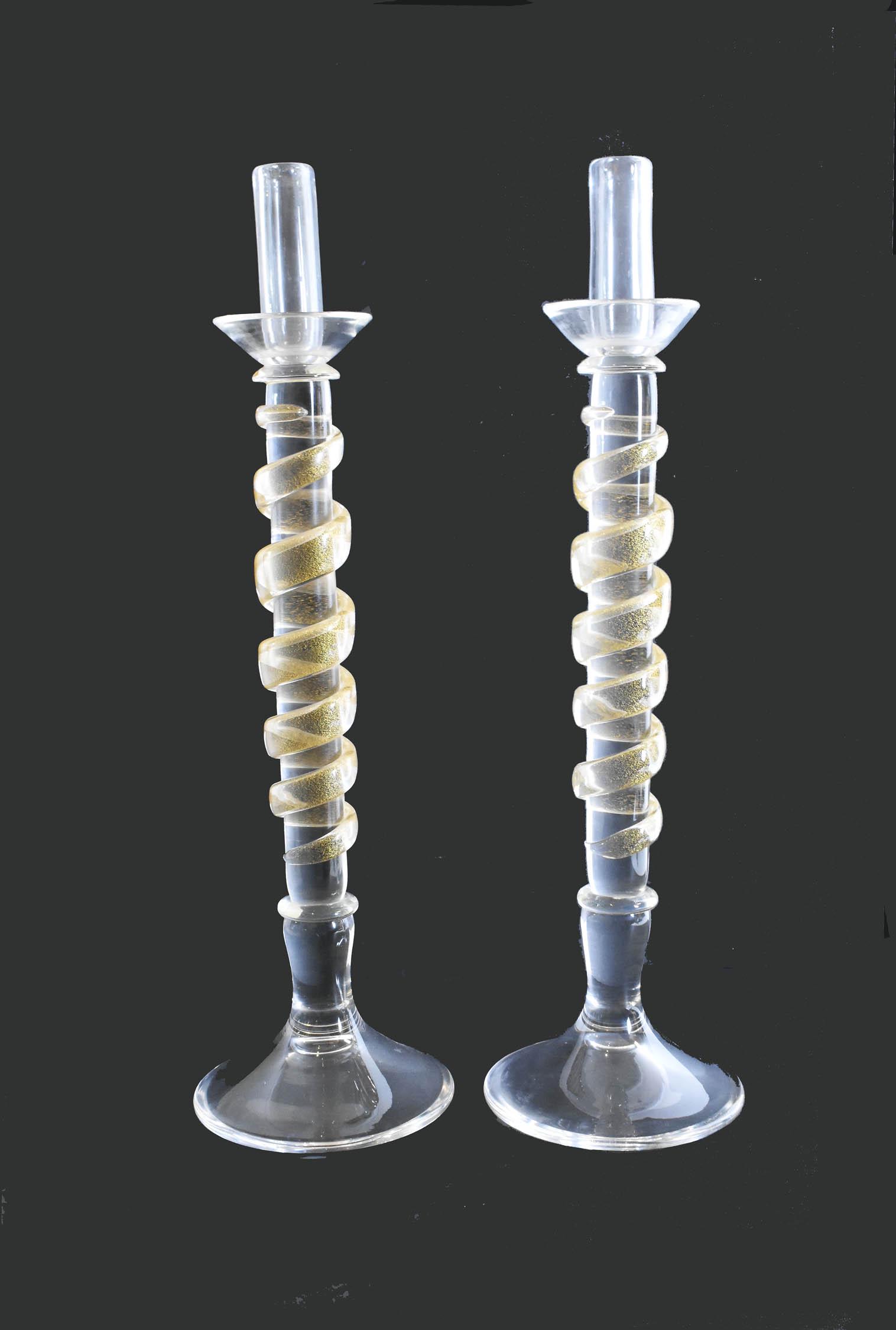 PAIR, VENETIAN GOLD-FLECKED COLORLESS GLASS CANDELABRA: Modern. The underside etched Murano. The shaft with spiraling strapwork, on a circular base. Height 25.75 in. Diameter at base 7 in.