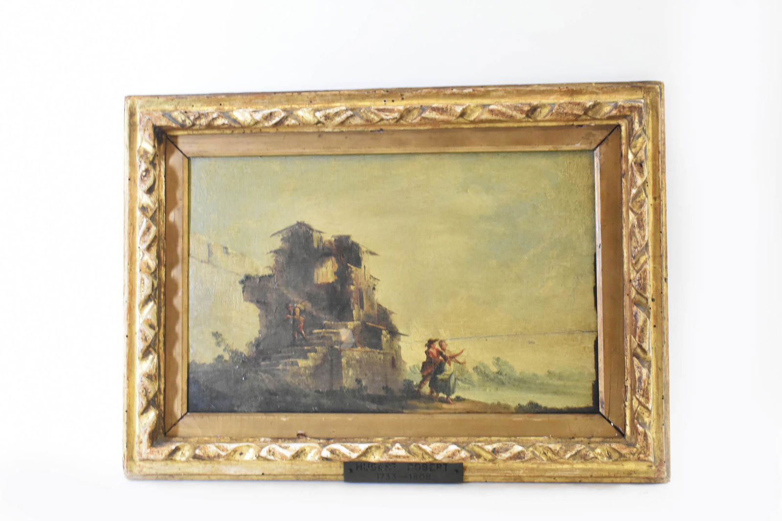 MANNER OF HUBERT ROBERT (FR. 1733-1808) PAINTING: Landscape with Figures in Antiquated Ruins. No Visible Signature. Oil on Panel. Verso bears exhibition label from Exposicion De Arte En La Universidad, Habana 1940. 9.75 x 15.5 in. . (Cond: Panel has