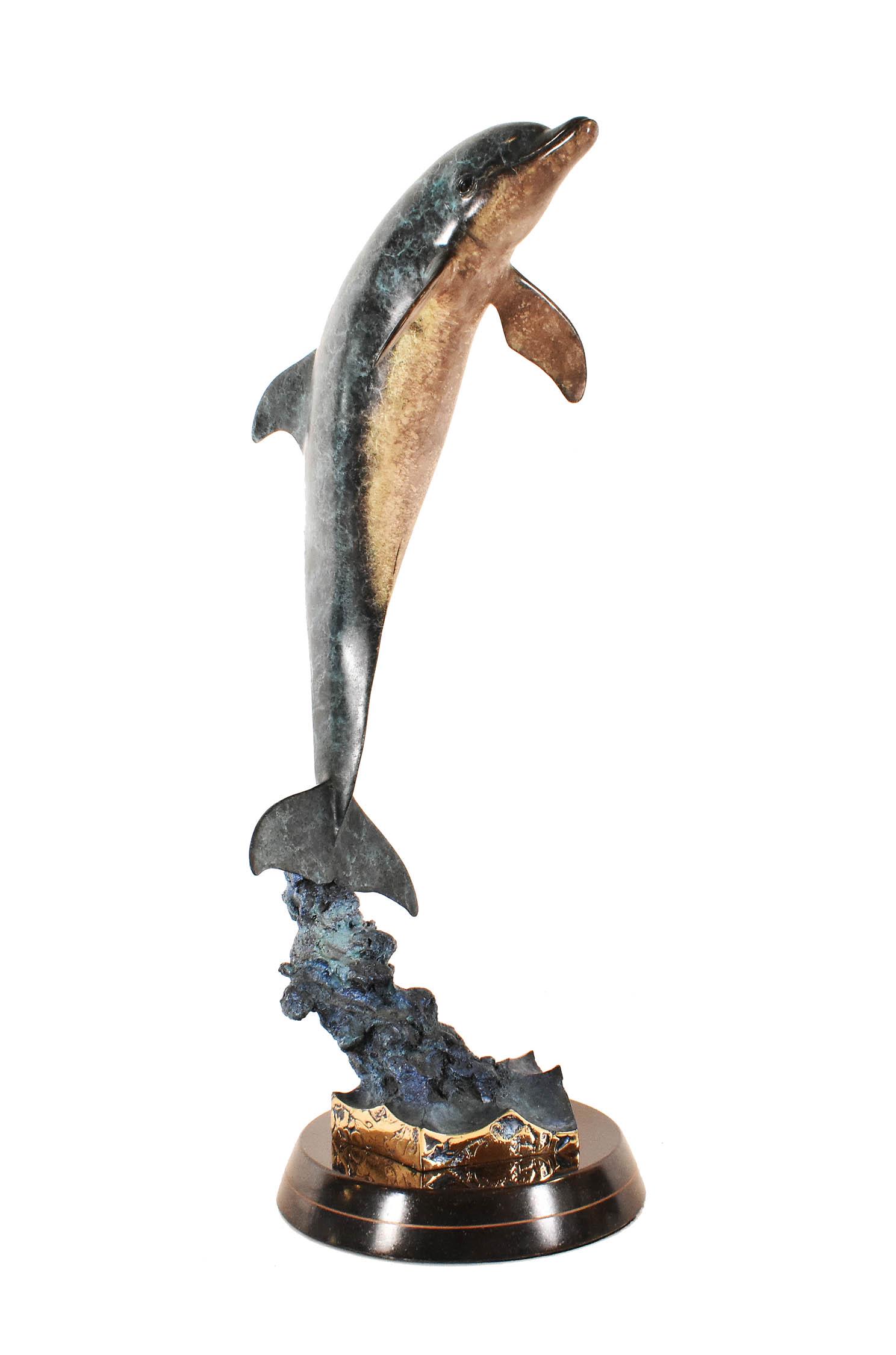 ROBERT WYLAND PATINATED BRONZE OF FRIENDLY DOLPHIN: Marked, copyright Wyland, from an edition of 99. On a circular black stone base. Height 29 in. Diameter at base 9 in.