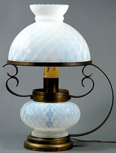 Opalescent Glass Table Lamp: Opalescent Glass Table Lamp with Mouth Blown Bell Shade and Glass Font. Lamp sits on Brass Stand with Curved Handle and Attached Circular Stepped Base. Light Bulb is Flame Shaped. Circa 20th Century.