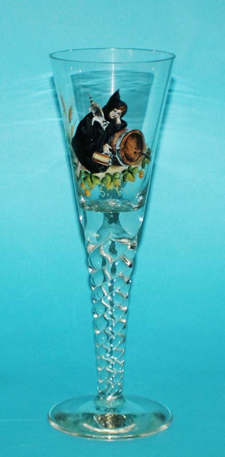 CLEAR GLASS GOBLET: CLEAR GLASS GOBLET German. The funnel shaped bowl enameled with a young maiden and a cat next to a barrel, raised on a spiral stem and round foot. Height 12 1/4". (125/175)