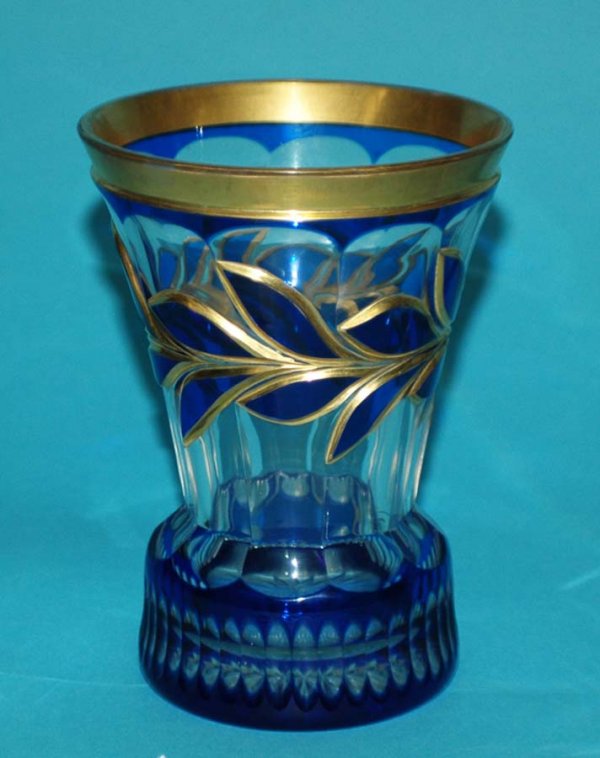 GROUP OF FOUR ASSORTED DRINKING VESSELS: GROUP OF FOUR ASSORTED DRINKING VESSELS Comprising: Royal Saxe porcelain goblet, height 7"; yellow tinted glass goblet, height 6 1/4"; blue and gold overlaid glass tumbler, height 5 3/4"; and a peacoc