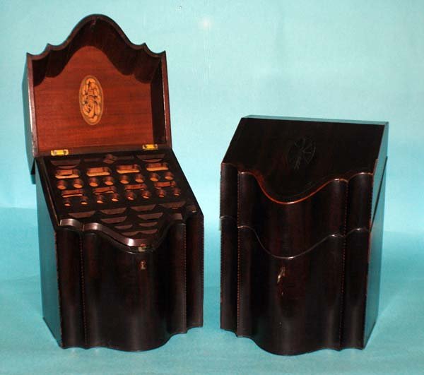 PAIR OF GEORGE III INLAID MAHOGANY KNIFE BOXES: PAIR OF GEORGE III INLAID MAHOGANY KNIFE BOXES .English. Circa 1810. Each shaped case with hinged cover opening to replaced spacers and a satinwood nautilus shell. Height 14". (Cond: restored, cracks 