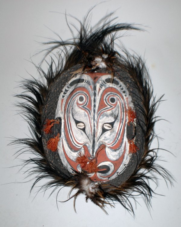 PAPUA NEW GUINEA SEPIK RIVER MASK: PAPUA NEW GUINEA SEPIK RIVER MASK Wood, shells, feathers, fibers and red ochre and white/black pipe clay paint. Approximately 19" high. (Cond: normal wear) (300/500)