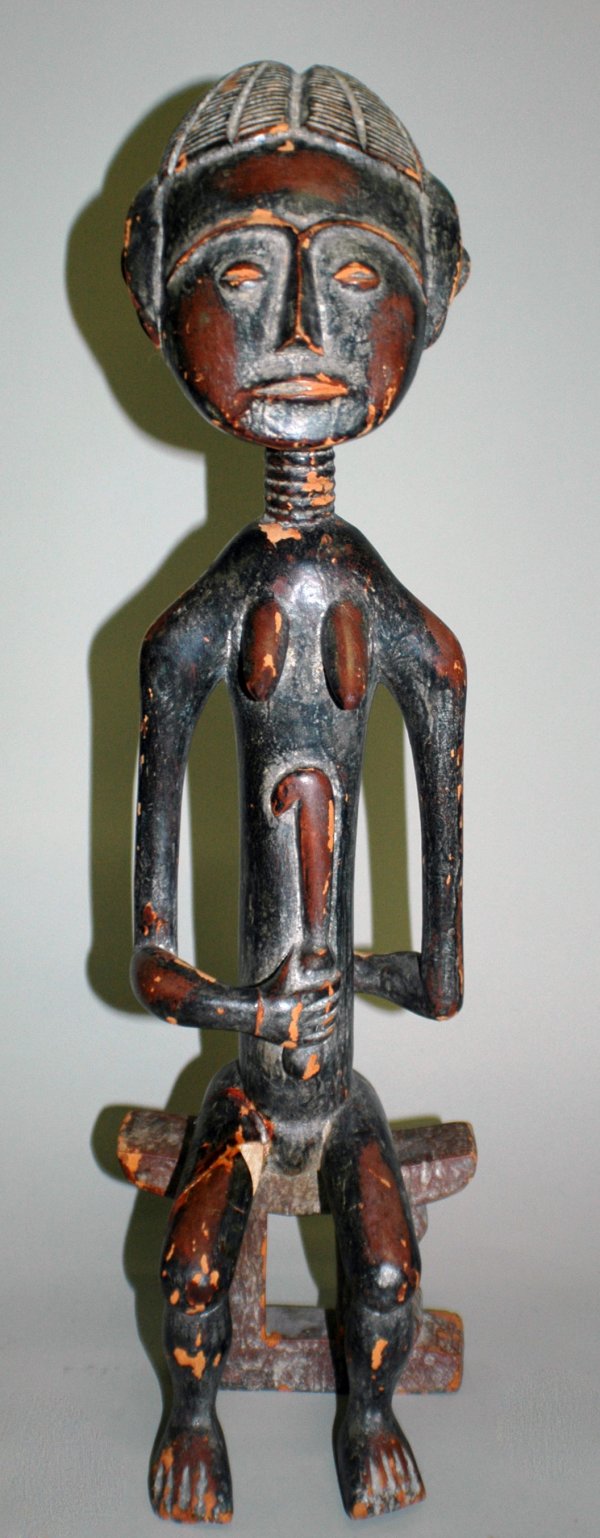 AFRICAN TRIBAL FERTILITY SCULPTURE: AFRICAN TRIBAL FERTILITY SCULPTURE Wood. Height 24 1/2". (Cond: leg broken and glued back, surface has normal wear with nicks, chips and abrasions) (60/80)
