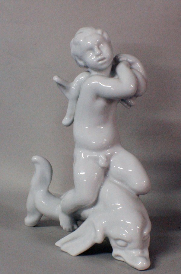 BING & GRONDAHL BLANC DE CHINE PORC. GROUP: BING & GRONDAHL BLANC DE CHINE PORCELAIN GROUP Danish. Model No. 58. Of a putto holding a baby dolphin riding a large dolphin. Height 8". (75/125)