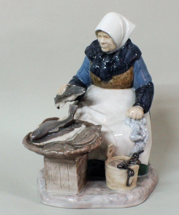 BING & GRONDAHL PORC. FIGURE OF A FISH SELLER: BING & GRONDAHL PORCEDLAIN FIGURE OF A FISH SELLER Danish. Modeled by Axe Locher. Signed. Model No. 2233. Height 8". (75/125)