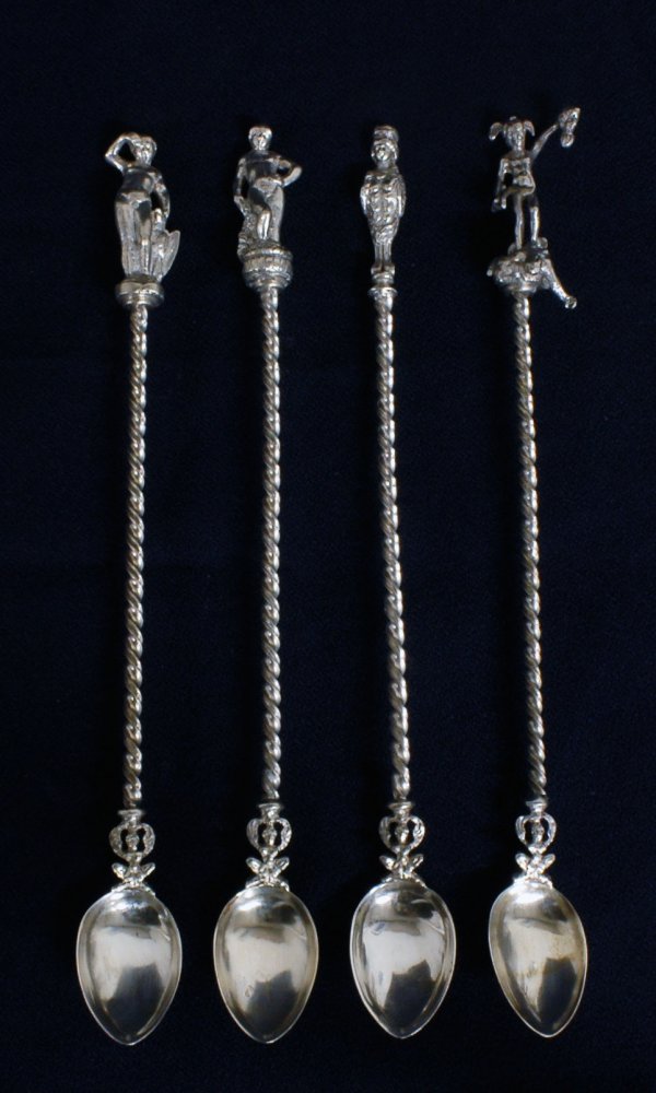 SET OF FOUR SILVER ICE TEA SPOONS: SET OF FOUR SILVER ICE TEA SPOONS Each with spiral handle ending in a figure. Length 9 1/8". (100/150)