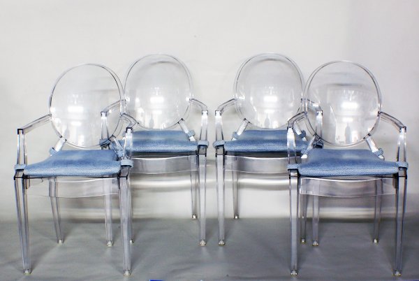 SET OF FOUR LUCITE DINING ARMCHAIRS: SET OF FOUR LUCITE DINING ARMCHAIRS Designed by Louis Ghost for Starck. By Kartell. Each stamped. (500/700)