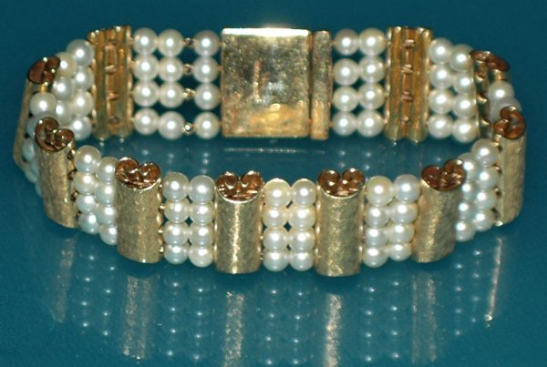 FOURTEEN KARAT YELLOW GOLD & PEARL BRACELET: FOURTEEN KARAT YELLOW GOLD & PEARL BRACELET By Lucian Picard. Composed of ten gold bars joined by two rows of four pearls. Length 7 1/2". (22.6 dwt) (750/1000)