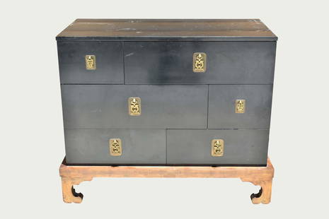 HOLLYWOOD REGENCY BLACK LACQUER CHEST ON GILT STAND: Circa 1950. Maslow, New York. In a Chinese Art Deco Style, the chest with stylized Chinese brass pulls, on a gilt wood stand. Height 34 in. Width 42 in. Depth 21 in.