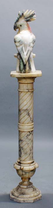 CARVED ALABASTER FIGURE OF A COCKATOO: Probably Italian. Perched on rockery. Height 19 1/2". Together with an alabaster pedestal, square top above a spiral standard. Height 42". (2 pcs) (600/800)