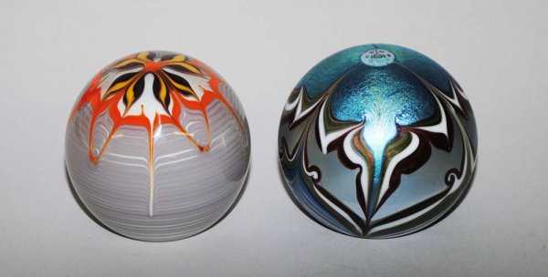 ORIENT AND FLUME GLASS PAPERWEIGHT: Signed, dated 1979 and No. 4543. With pulled feather design. Diameter 3". Together with a Bridgeton Studios flower weight, dated '78 and No. 8-111. Signed by the artist, Buzzini. Diameter 2 5/8". (2 p