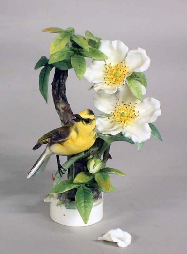 DOROTHY DOUGHTY "HOODED WARBLER WITH CHEROKEE ROSE : English. Dated 1961. By Royal Worcester. Limited Edition of 500. Height 9 1/2". With original wood box. (Cond: one loose leaf)