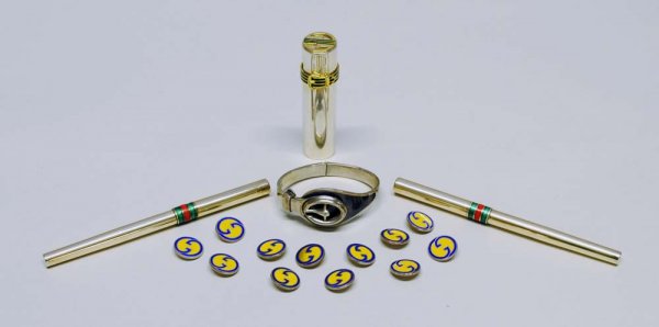 GUCCI STERLING SILVER AND ENAMEL CUFF: Italian. (Cond: chip to enamel) Together with a Gucci sterling silver and enamel lipstick holder, two pens and twelve buttons.