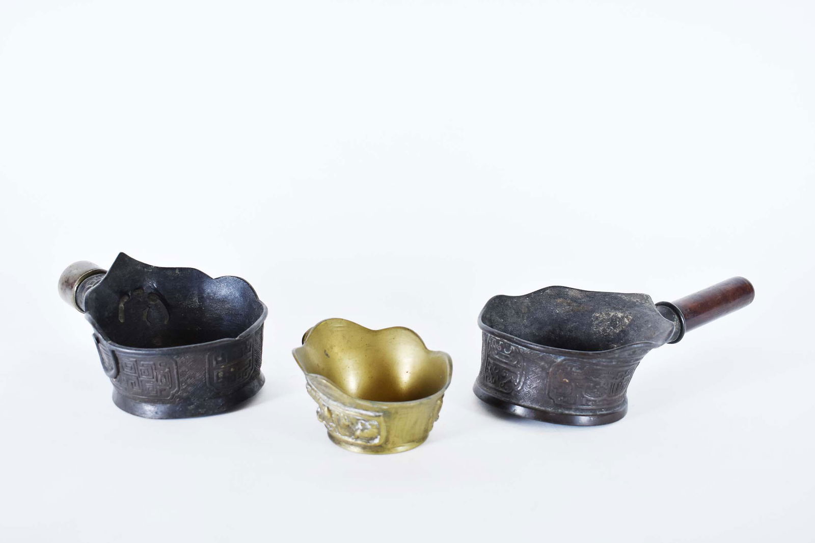 THREE CHINESE BRONZE SILK IRONS (1 of 10)