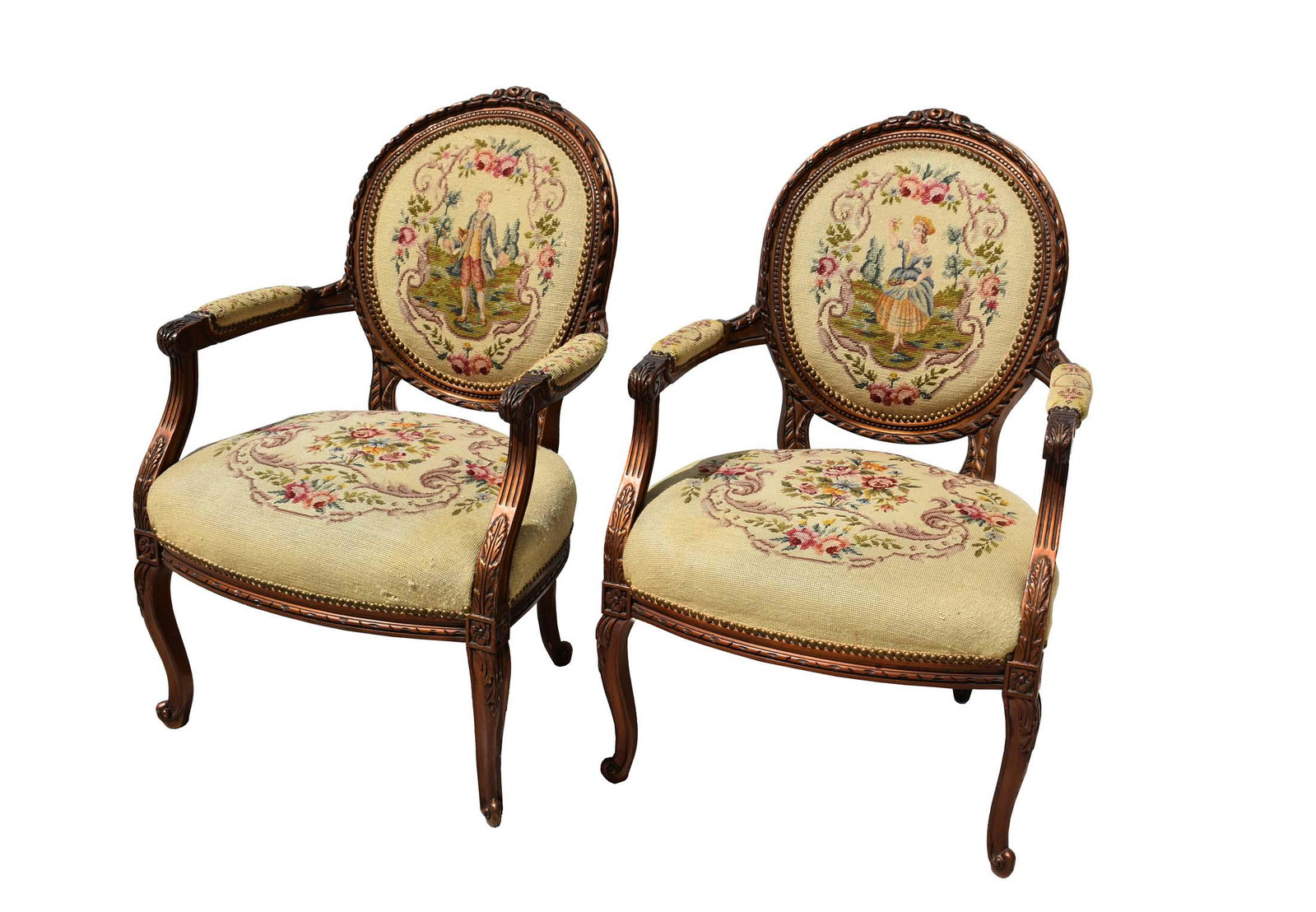 PAIR OF FRENCH NEEDLEPOINT-UPHOLSTERED BEECHWOOD: Circa 1930. In a transitional Louis XV/XVI Style, carved with foliage and geometric, the needlework with figures and a floral bouquet.