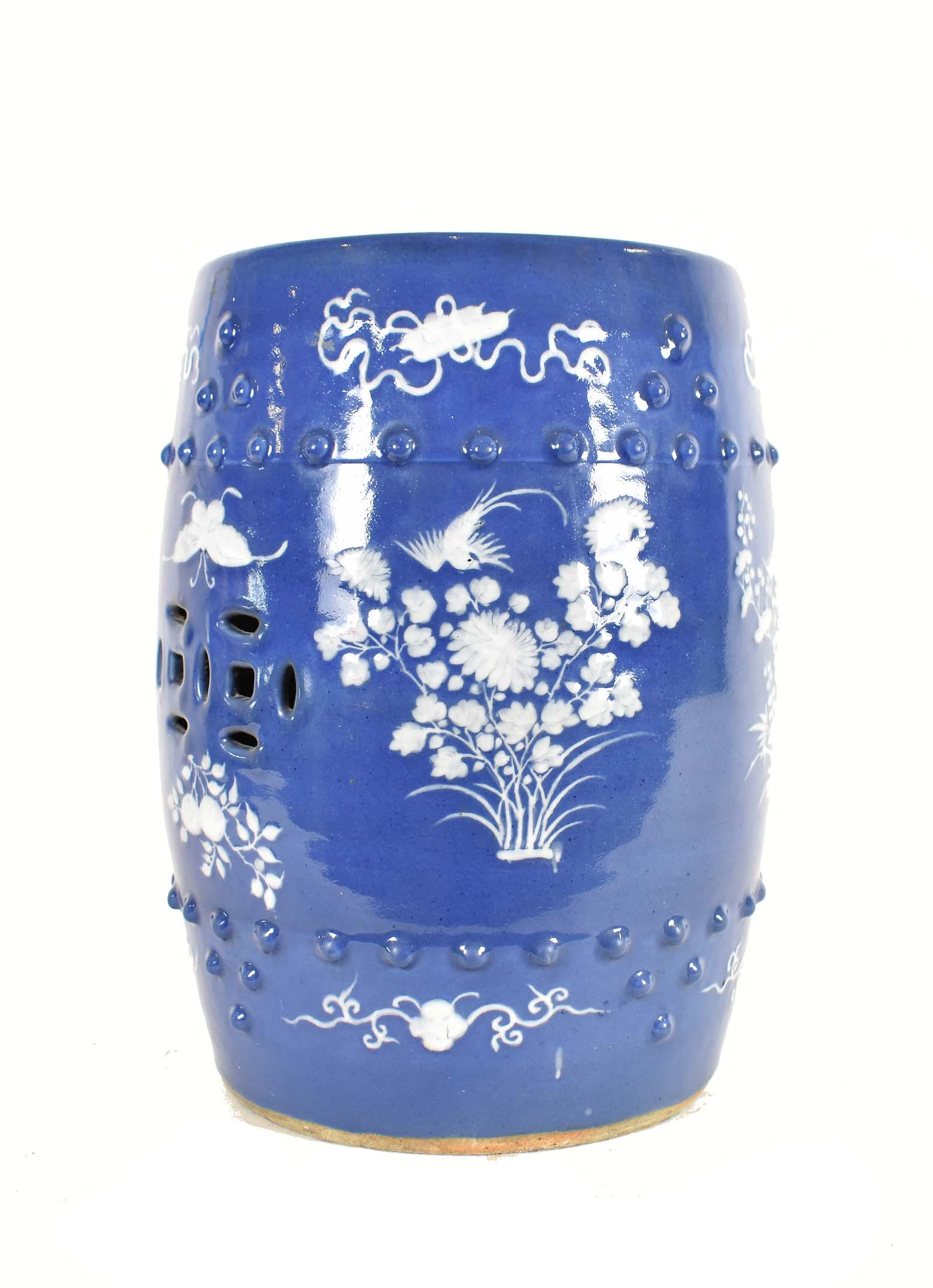 CHINESE SLIP-DECORATED PORCELAIN GARDEN STOOL: 20th Century. Decorated with textured white slip to depict birds amidst foliage with antique symbols within an upper and lower raised bead border, on a powder blue ground. Height 19 in. Diameter 12.5 