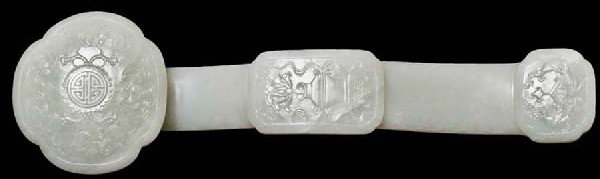 VERY FINE LIGHT GREEN JADE RUYI SCEPTER: Chinese. The plaques carved with Shou symbol, bats, fish and a vase. Length 13 3/4". (12000/16000)