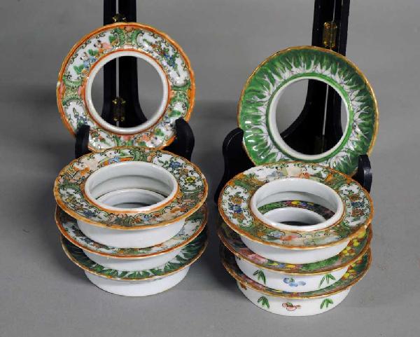 GROUP OF EIGHT PORCELAIN TEA CUP STANDS: Chinese. 19th Century. Comprising: four rose medallion, two famille rose and two famille verte. Each circular stand with scalloped edge. Diameter 4 1/8". (Cond: chips) (100/150)