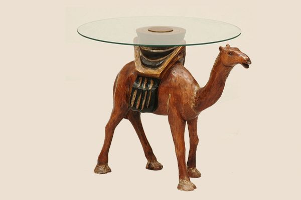 1920 Camel Side Table with Glass top: 1920 Camel Side Table with Circular Glass Top. Base Hand Carved Wood Camel Standing on all Fours with Saddle on Back. Measures 22-1/2 Inches Tall 24 Inches Diameter. Good Condition. We Will Not Ship N