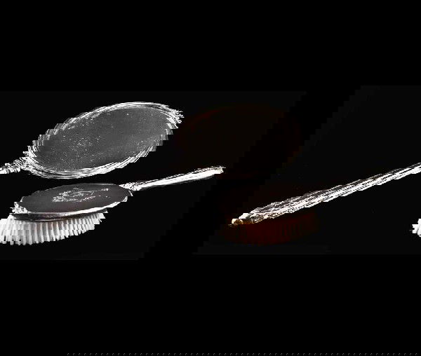 STERLING SILVER HAND MIRROR AND BRUSH: American. 20th Century. Maker: R. Blackington & Co. Length of hand mirror 15". (150/200)