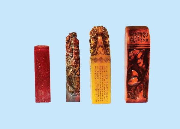 GROUP OF FOUR SOAPSTONE SEALS: Chinese. Each with calligraphy and carved on the underside in intaglio. Heights 3 3/8" to 4 5/8". (300/400)