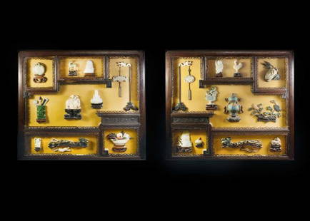 GOOD PAIR OF JADE OVERLAID SHADOW BOX WALL PLAQUES: Chinese. Each rectangular frame with an arrangement of windows showing various jade and hardstone figures and objects. Measuring 20 5/8" by 23 7/8". (1000/1500)