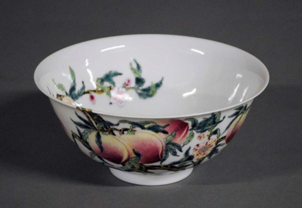 FINE PORCELAIN PEACH BOWL: Chinese. Four character seal mark of Qianlong but of a later period. Painted internally and externally with peaches and bats. Diameter 6 1/8". (500/700)